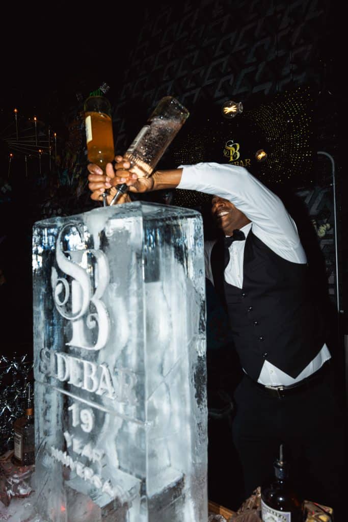 Group enjoying bottle service during an anniversary party at Side Bar